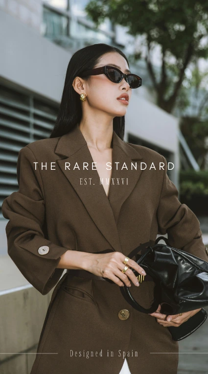 The Rare Standard fashion creative featuring a model in a brown coat.